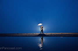 Rainy day engagement photos at the beach.